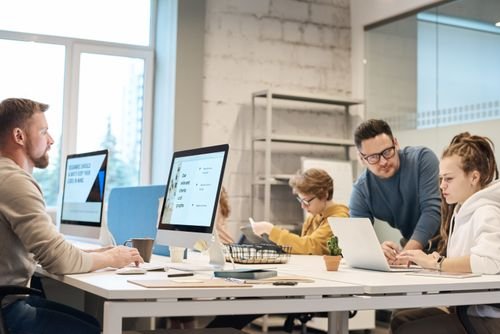 Equipo de profesionales de Planet Earth Informática trabajando junto a computadoras